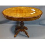 A 19th century burr elm Biedermeier centre table, the oval gadrooned edged top on a well carved