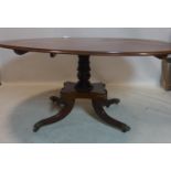 A Regency mahogany tilt top dining table, raised on turned pillar support, quadriform base, 4