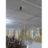An eight branch chandelier with glass shades