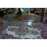 An oval glass topped dining table on pierced gilded metal base H.77 L.196 D.55cm