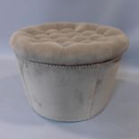 A contemporary ottoman footstool with studded velour upholstery and buttoned lid