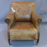 A 20th century stud bound brown leather club armchair, H.83 W.84cm, heavily worn, with cracks to