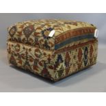 An Ottoman stool, upholstered with antique Russian carpet, raised on castors, H.40 W.61 D.55cm