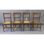 A set of four Edwardian inlaid mahogany chairs with cane seats