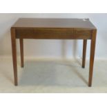 An oak writing table, with single drawer, stamped AM to base, raised on tapering chamfered legs, H.