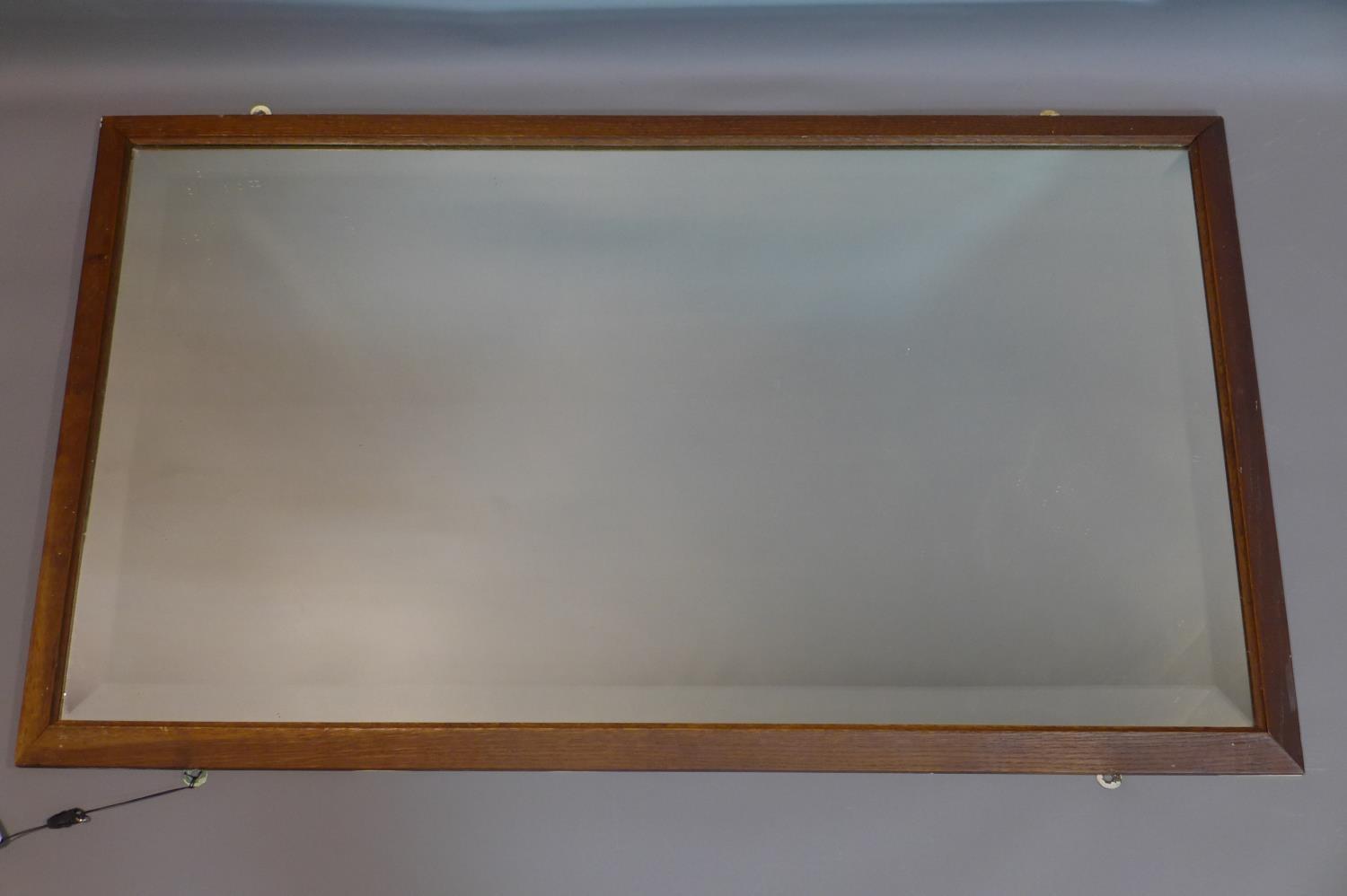 An oak framed mirror, with bevelled plate, 98 x 57cm