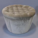 A contemporary ottoman footstool with studded velour upholstery and buttoned lid