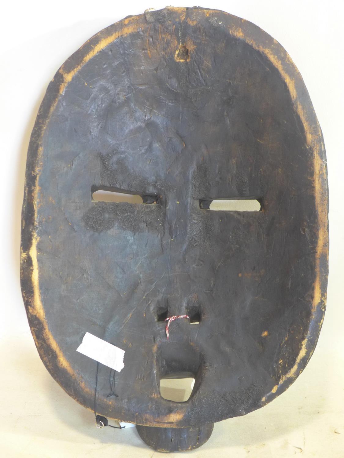 A 20th century African tribal mask, with cowrie shells, beads and copper inlay, H.52 W.37cm - Image 3 of 3