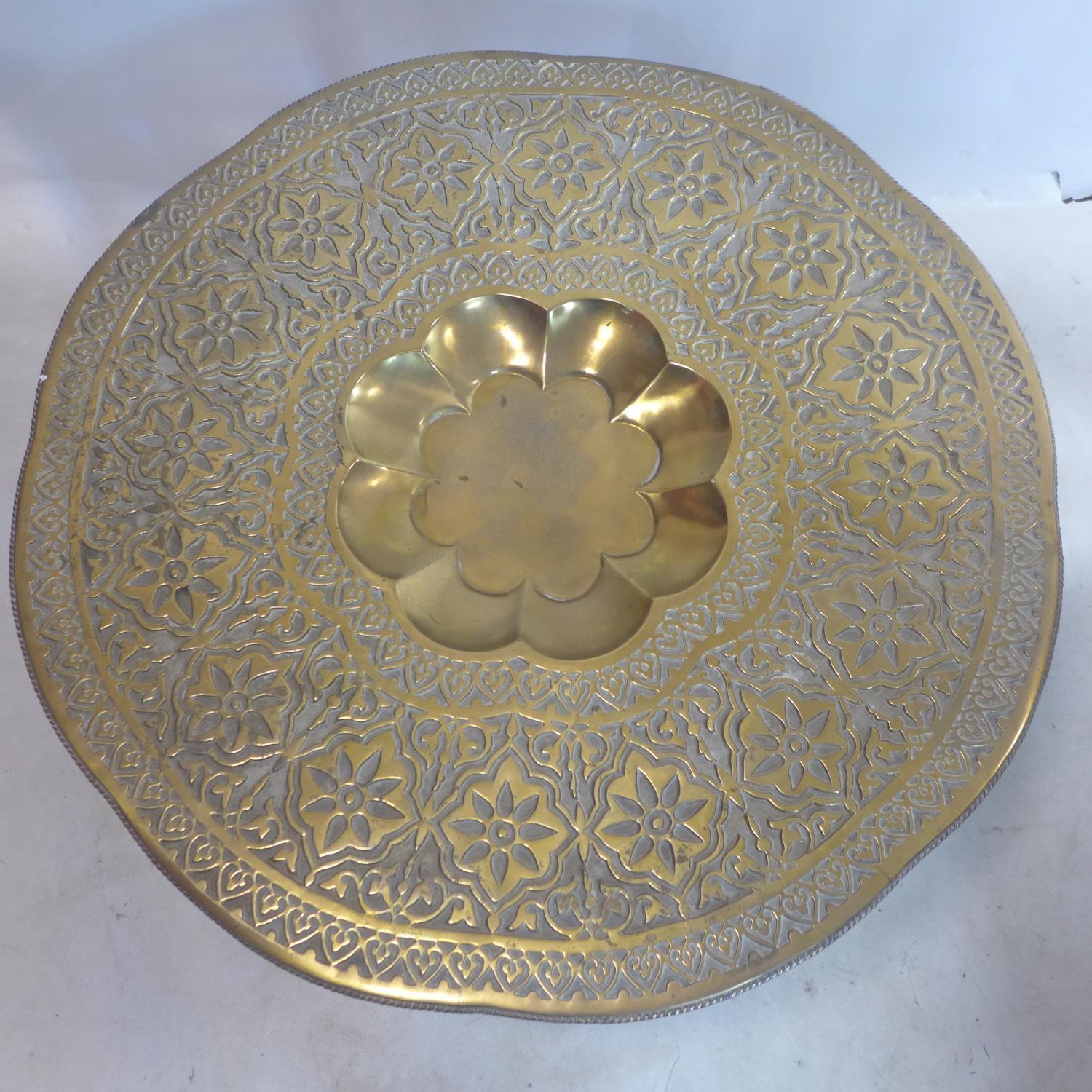 A 20th century Moroccan tea table, with brass tray top on folding base, H.50 D.78cm - Image 2 of 2