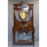A Victorian Aesthetic mahogany hallstand, having shield mirror with bevelled plate, with single
