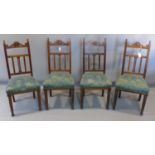 Four Art Nouveau oak dining chairs, with peacock feather design upholstered seats
