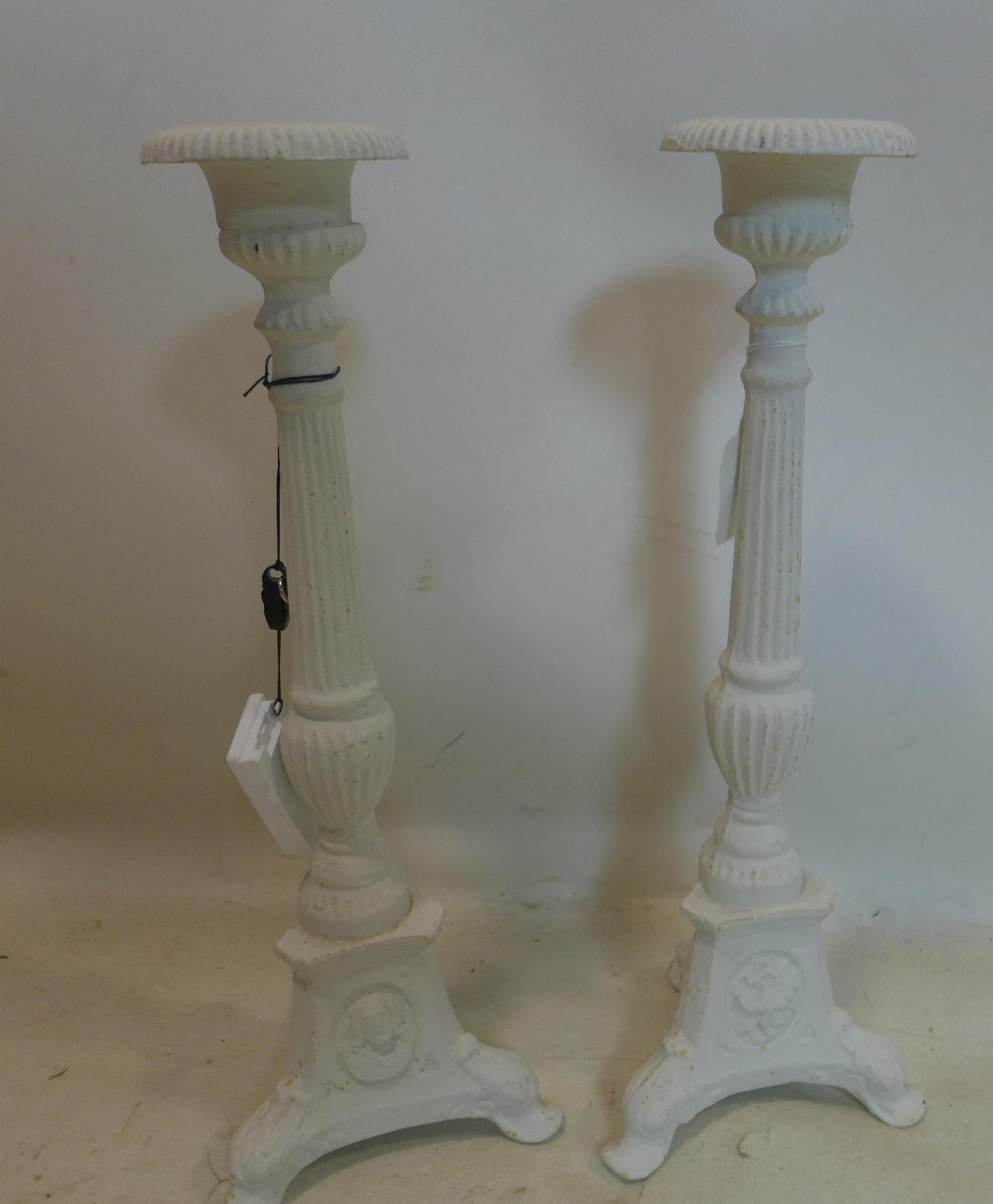 A pair of white painted cast iron pricket sticks, H.43cm