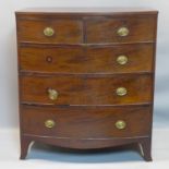 A Regency mahogany bow fronted chest of 2 short over 3 long graduating drawers, on splayed feet, H.