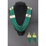 An Indian emerald beaded necklace with enamelled plaques, together with a matching pair of earrings