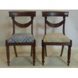 A pair of Regency mahogany chairs, with later floral upholstered drop-in seats, raised on reeded