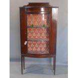 An Edwardian inlaid mahogany display cabinet, with lead glass door, raised on tapered legs, H.150