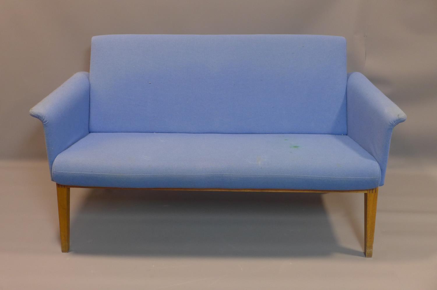 A blue 2 seater Lazy Sofa by Swedese, with stain to seat