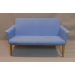 A blue 2 seater Lazy Sofa by Swedese, with stain to seat