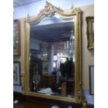 A late 19th / early 20th century giltwood and gesso overmantle mirror, with later bevelled plate,