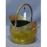A brass hammer helmet coal scuttle