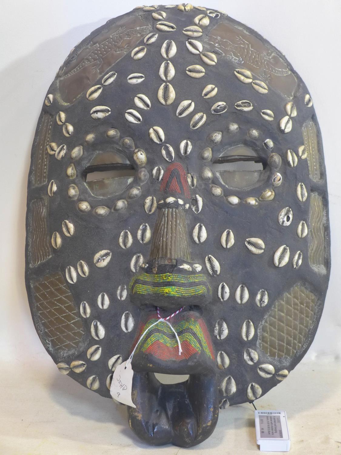 A 20th century African tribal mask, with cowrie shells, beads and copper inlay, H.52 W.37cm