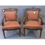 A pair of William IV mahogany armchairs with scroll arms