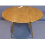An Ercol elm and beech drop leaf table, raised on splayed legs, H.73 L.112cm