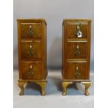 A pair of walnut pedestal chests of three drawers, raised on cabriole legs, H.88 W.27 D.43cm (2)