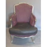 A Louis XV style armchair, with purple upholstery and leatherette cushion, raised on cabriole