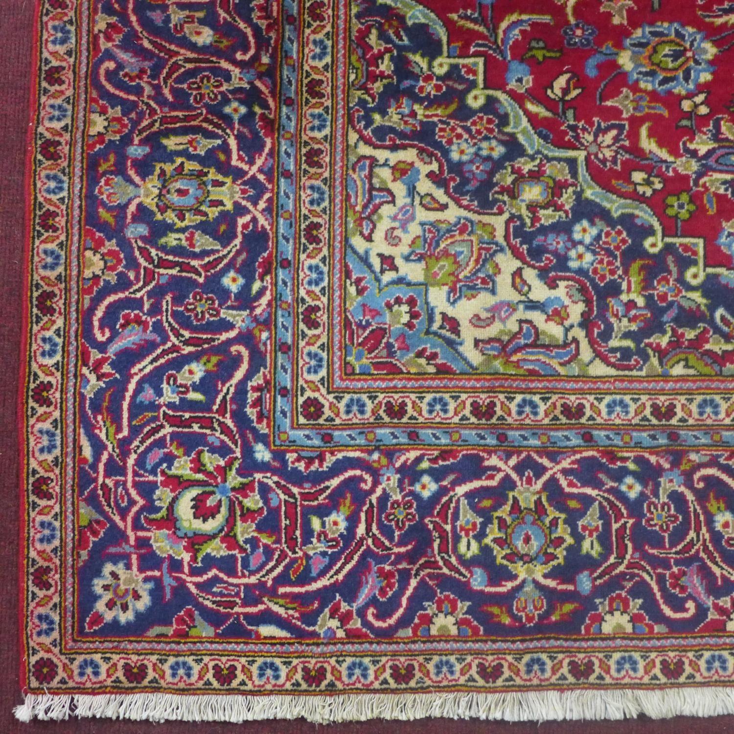 a central Persian Kashan carpet, the central double medallion with repeating petal motifs on a rouge - Image 4 of 5