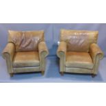 A pair of leather armchairs raised on turned feet, H.90 W.96 D.96cm