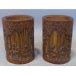 Two 19th century Chinese bamboo brush pots, with pierced carving of figures in a bamboo grove, H.