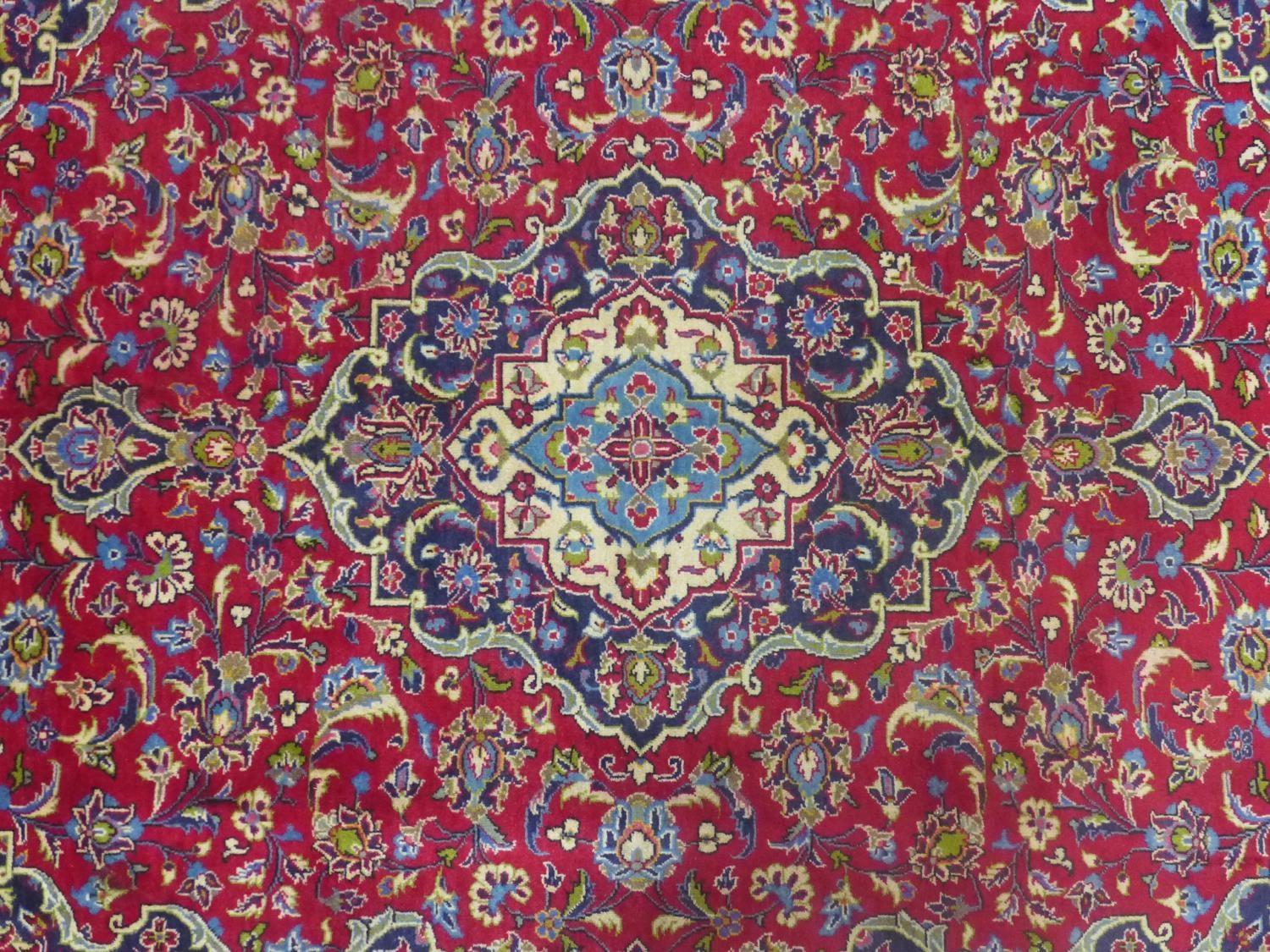 a central Persian Kashan carpet, the central double medallion with repeating petal motifs on a rouge - Image 2 of 5