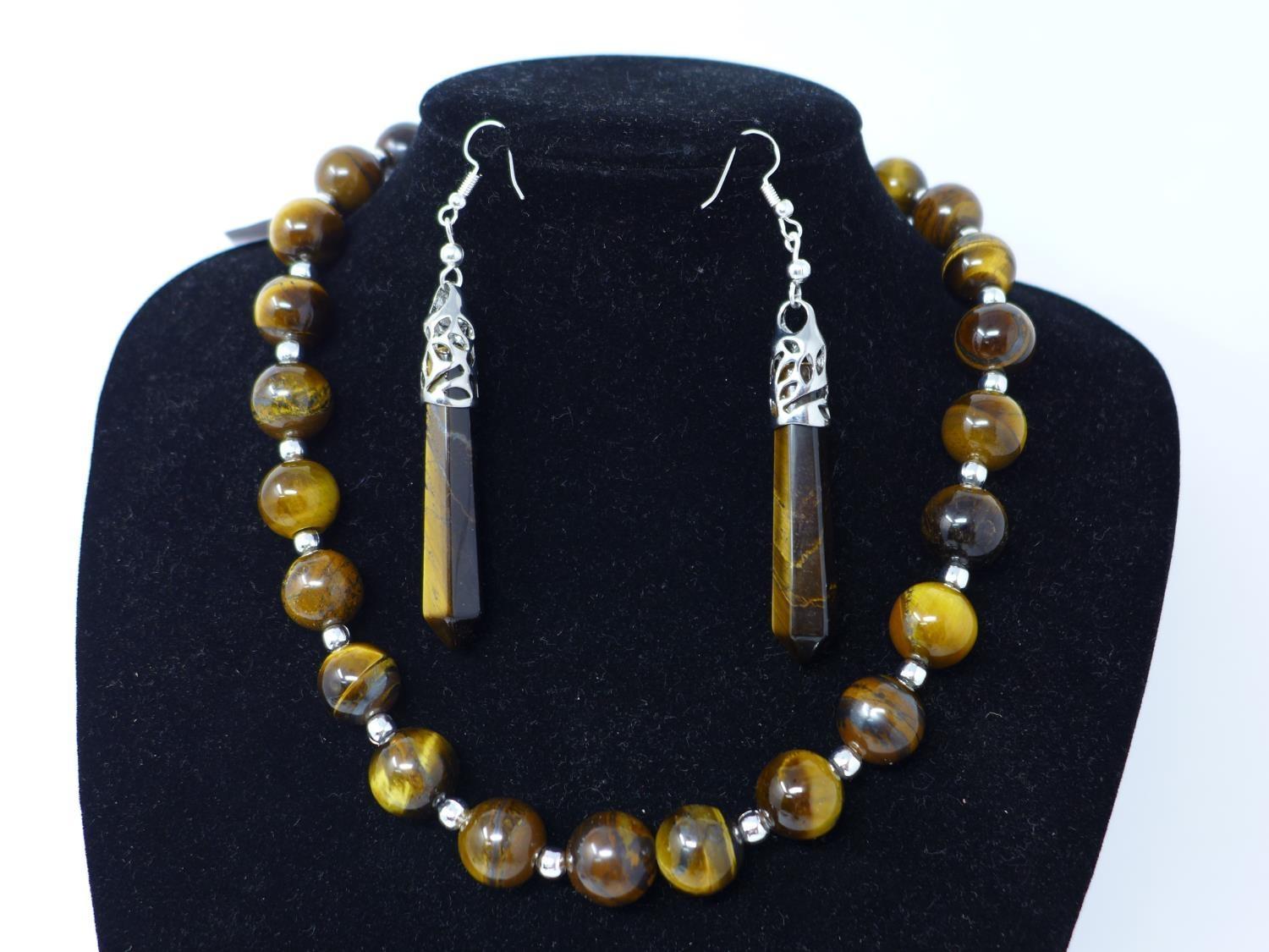 A Tiger's eye beaded necklace, a tiger's eye pendant and a pair of tiger's eye earrings, each with