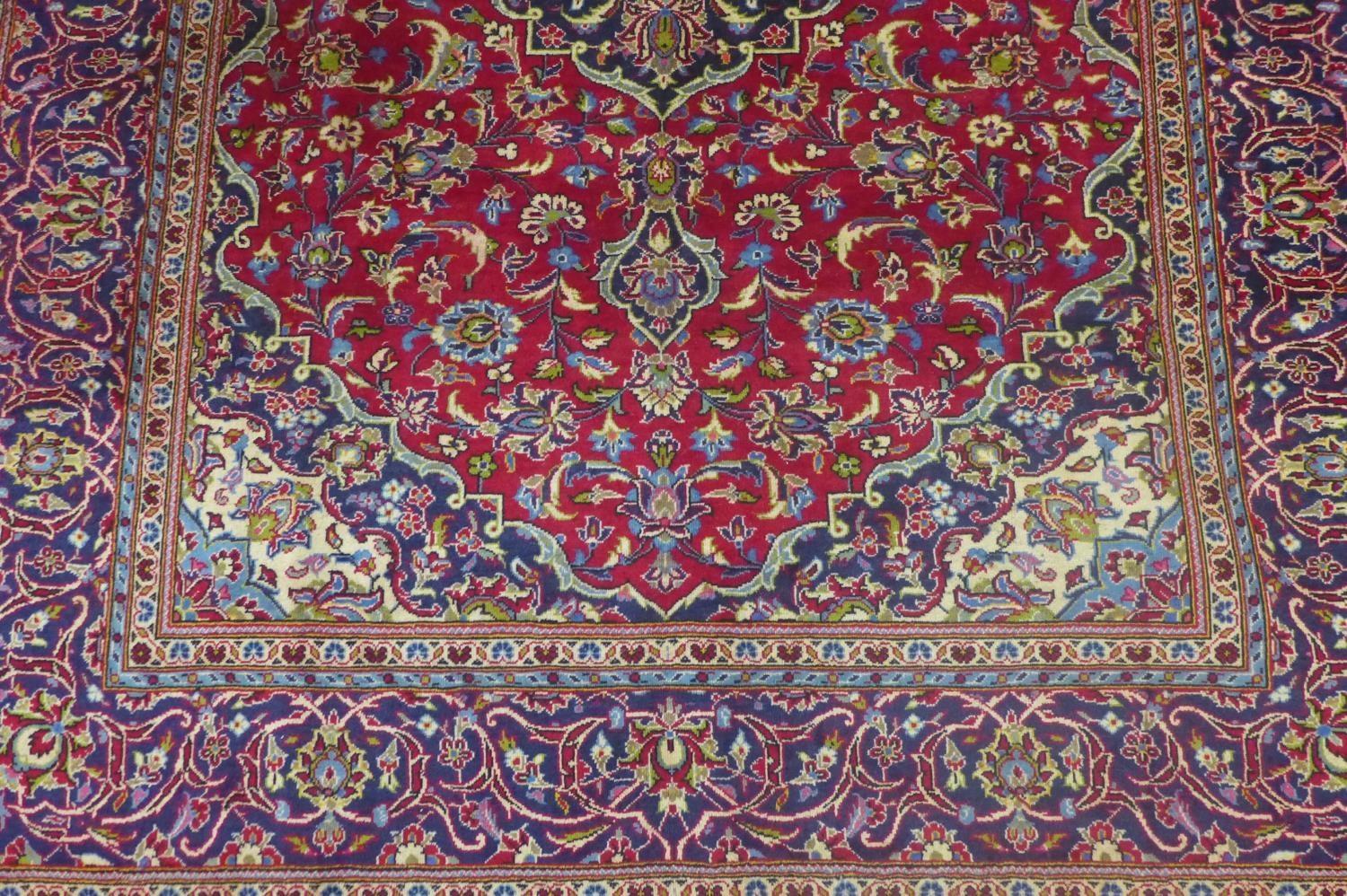 a central Persian Kashan carpet, the central double medallion with repeating petal motifs on a rouge - Image 3 of 5