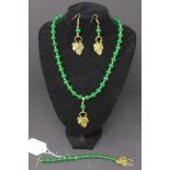 A set of jade beaded jewellery; necklace, bracelet and earrings