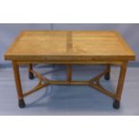 A Gordon Russell Japanese oak extendable dining table, with two extra leaves, raised on octagonal