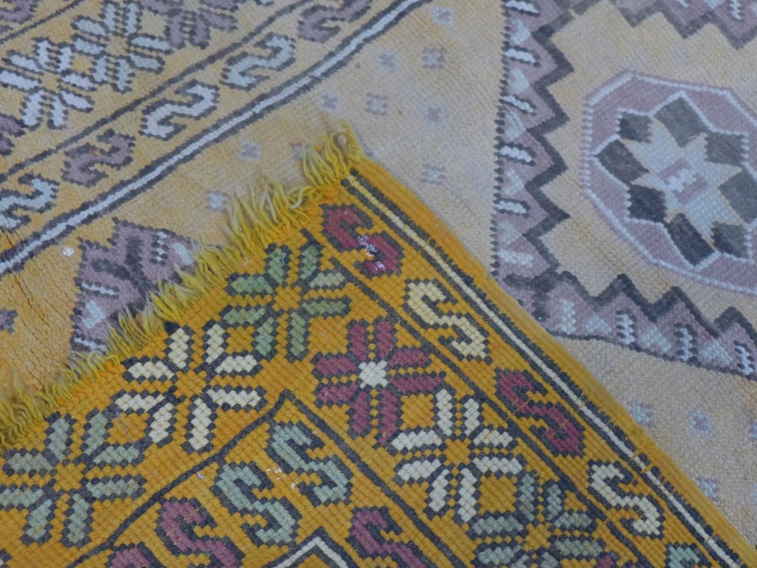 A Moroccan rug, with triple diamond pole medallions on an orange ground, within stylised floral - Image 5 of 5