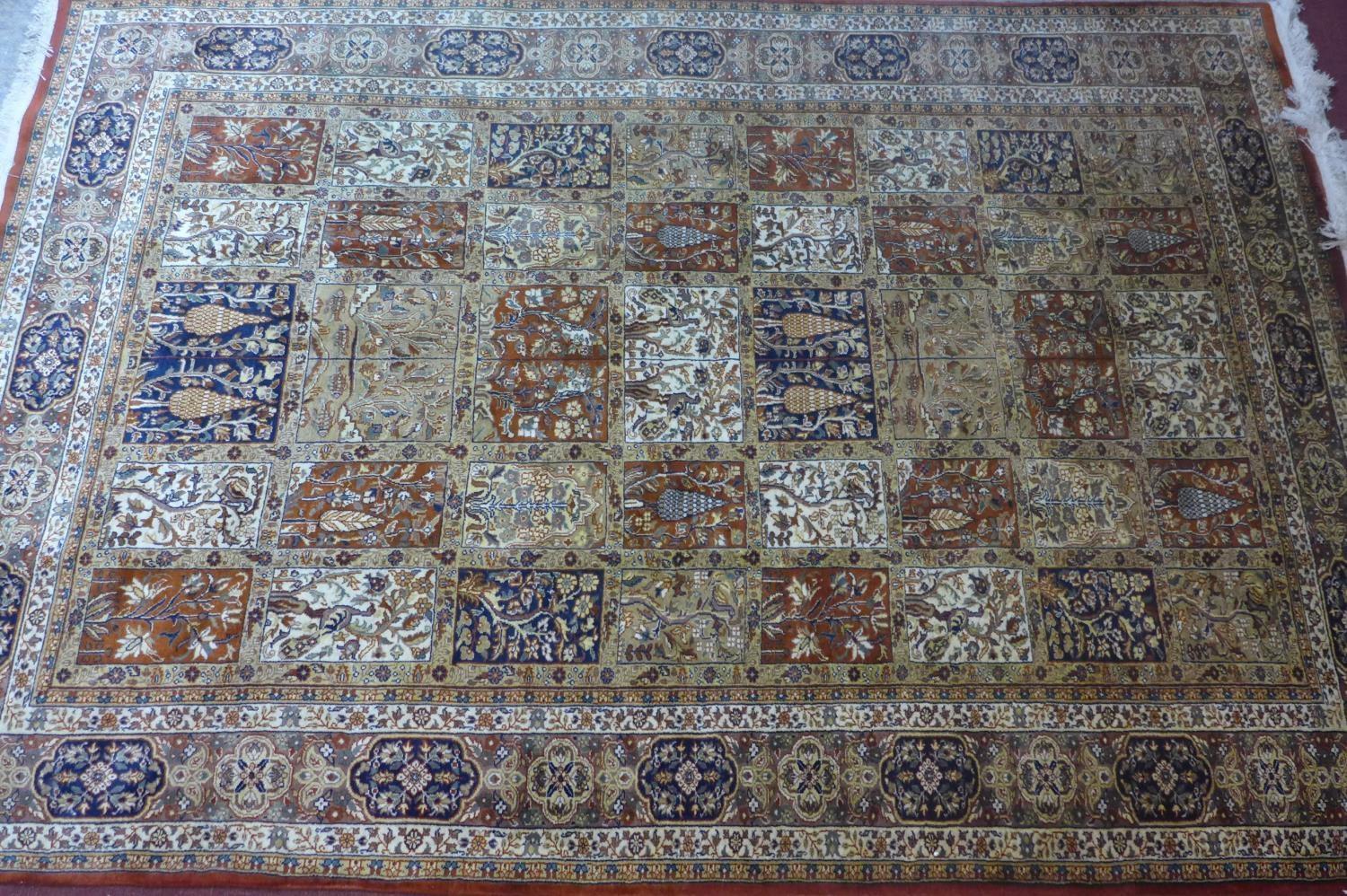 A Persian Tabriz carpet, made from English wool, with garden design having panels of stylised