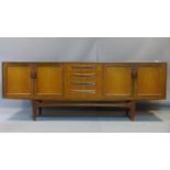 A G-plan teak long sideboard, with four central drawers and four cupboard doors, on tapered legs