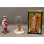 Three Japanese dolls, to include one in a glass dome on enamel stepped circular base, H.27cm (doll),