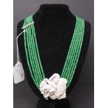 A green emerald chip multi strand necklace with floral clasp