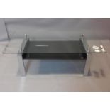 A contemporary chrome and glass low table, with black tempered glass undertier, H.43 W.120 D.60cm