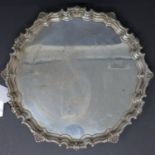 A silver salver, by William Suckling Ltd, London 1939, with scalloped rim with shell and floral