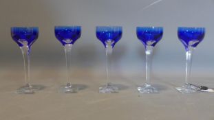 A set of 5 blue glasses signed by Moser. H.22cm