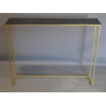 A contemporary gilt console table with black painted top, H.82 W.100 D.20cm