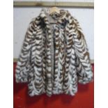 A vintage white and brown fur jacket, possibly mink