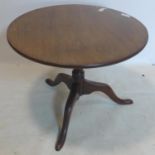 A late 19th century mahogany circular low tilt top table, raised on three cabriole feet, H.52cm