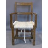 An oak chair with rope seat, on square tapered legs joined by stretcher