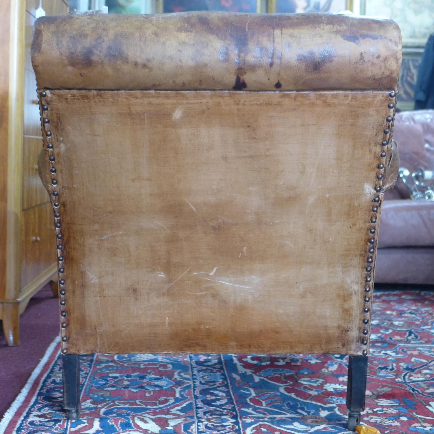 A 20th century stud bound brown leather club armchair, H.83 W.84cm, heavily worn, with cracks to - Image 3 of 3
